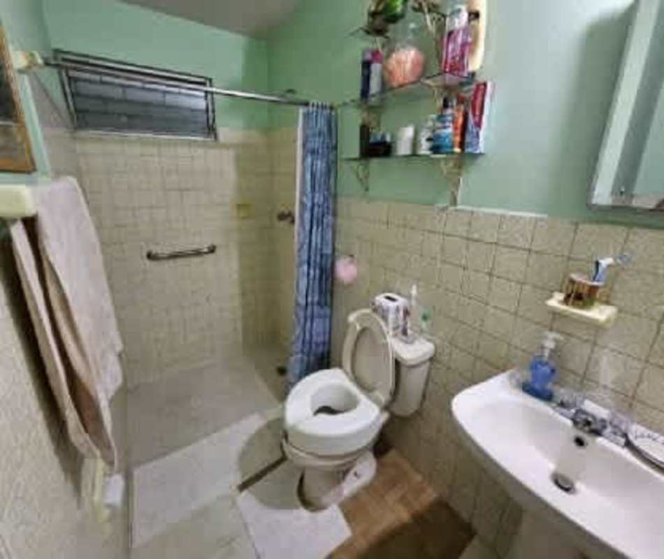 Covered patio with tiled flooring and metal security bars in Chanis Panama home