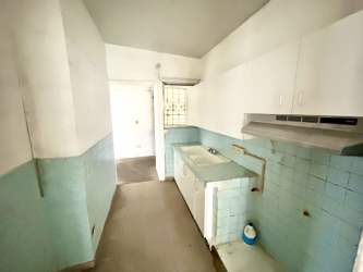 Narrow kitchen area with cabinets and tile in Bello Amor Arraiján house