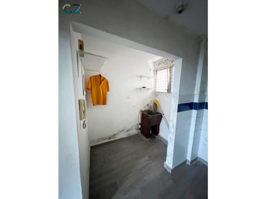 Laundry area with utility sink and storage shelves PH Coco del Mar San Francisco Panama