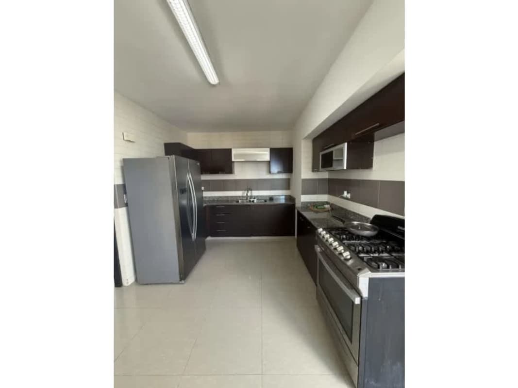 Fully-equipped modern kitchen with stainless steel appliances and granite countertops at PH Infinity San Francisco Panama
