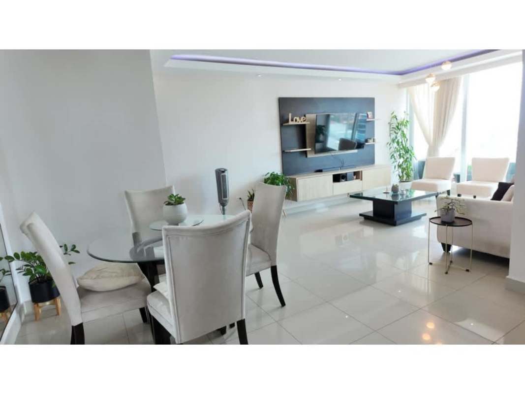 Dining area with glass table, mirror wall and minimalist decor at PH The Hill Tower Panama City