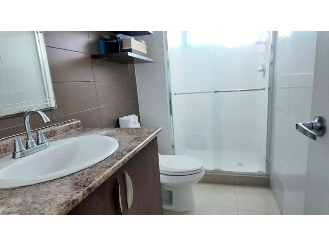 Elegant bathroom with modern granite vanity and glass enclosed shower in PH The Hill Tower Panama City