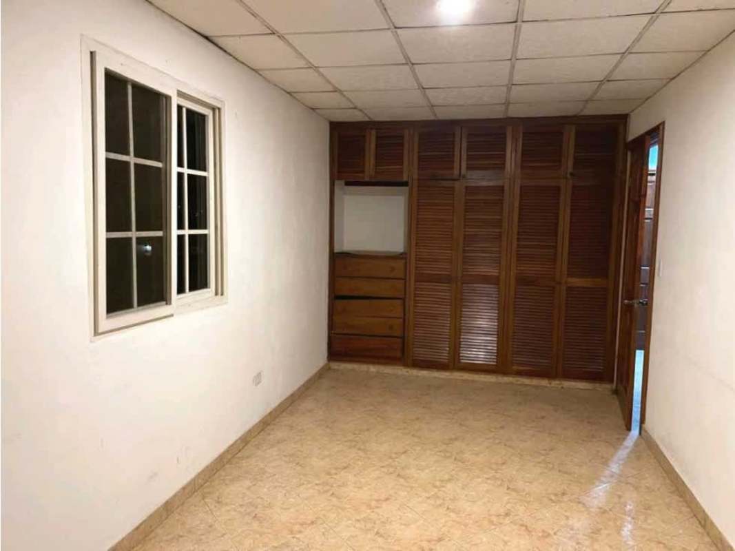 Bedroom featuring sliding window, built-in wardrobe, tile floor in rental house Panama City