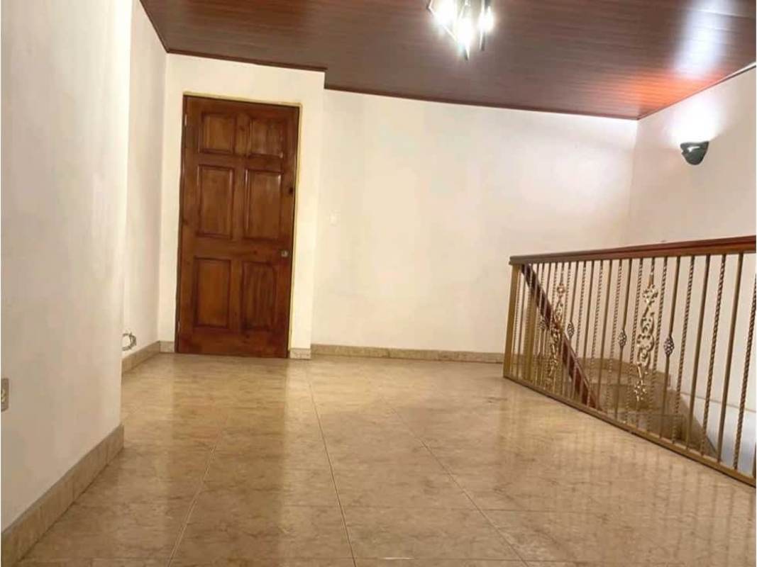 Bedroom with windows showing city street lights, tiled floor rental house Panama