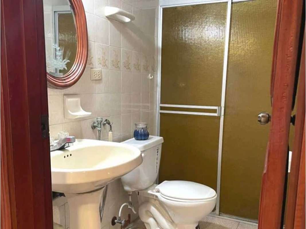 Bathroom with pedestal sink, gold-tint glass shower doors, wall mirror Hato Pintado Panama rental