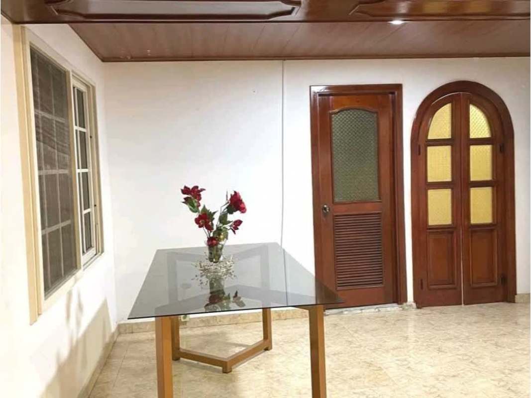 Indoor staircase with beige tile steps, gold railing, wood handrail in Hato Pintado Panama rental house