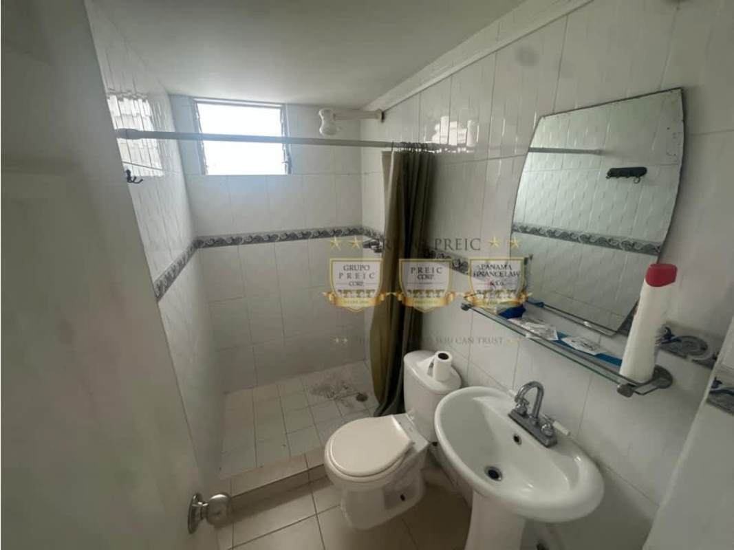 Small bathroom with tile walls, shower and pedestal sink in PH Parque Lindo Panama City