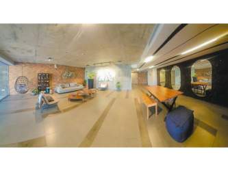 Elegant living room with wall accents, large mirror, wood paneling in Panama Pacifico condo