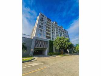 Modern laundry room with washer dryer hookups, utility sink, and cabinetry in Panama Pacifico apartment