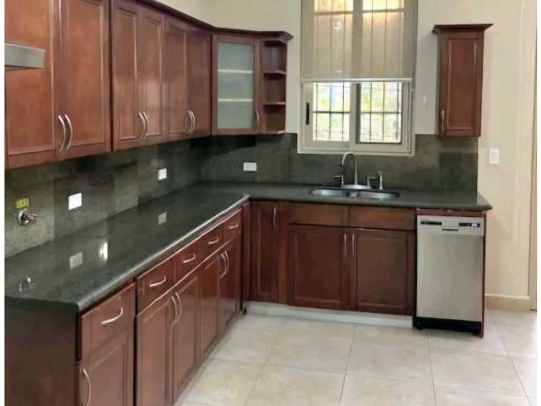 Traditional kitchen with granite countertops, wood cabinets and dishwasher in PH Embassy Gardens Clayton Panama City
