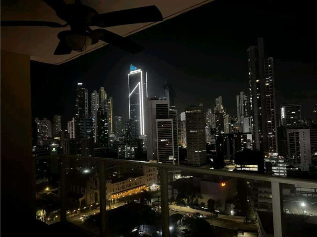 Rooftop pool illuminated at night overlooking Panama City skyline at PH Diana Tower