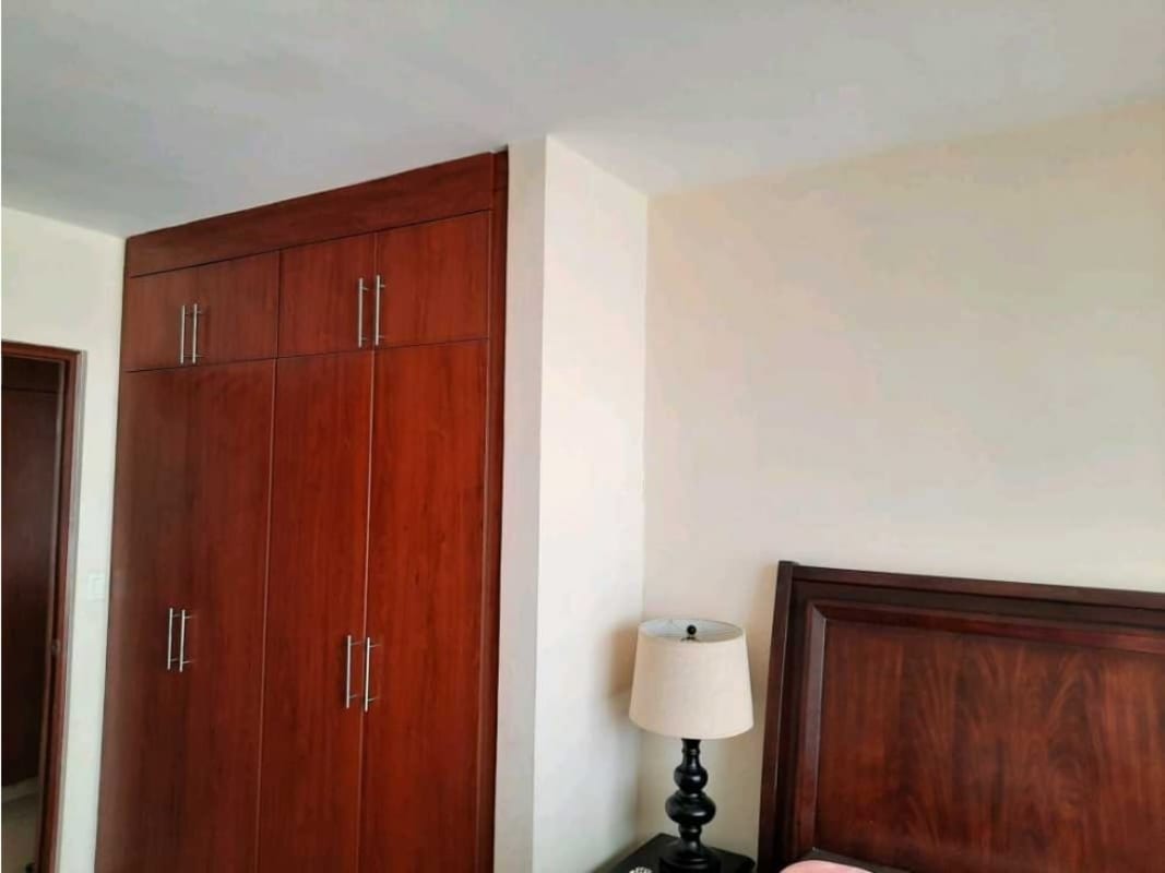 Bright living room with large windows showing panoramic city view in PH Diana Tower