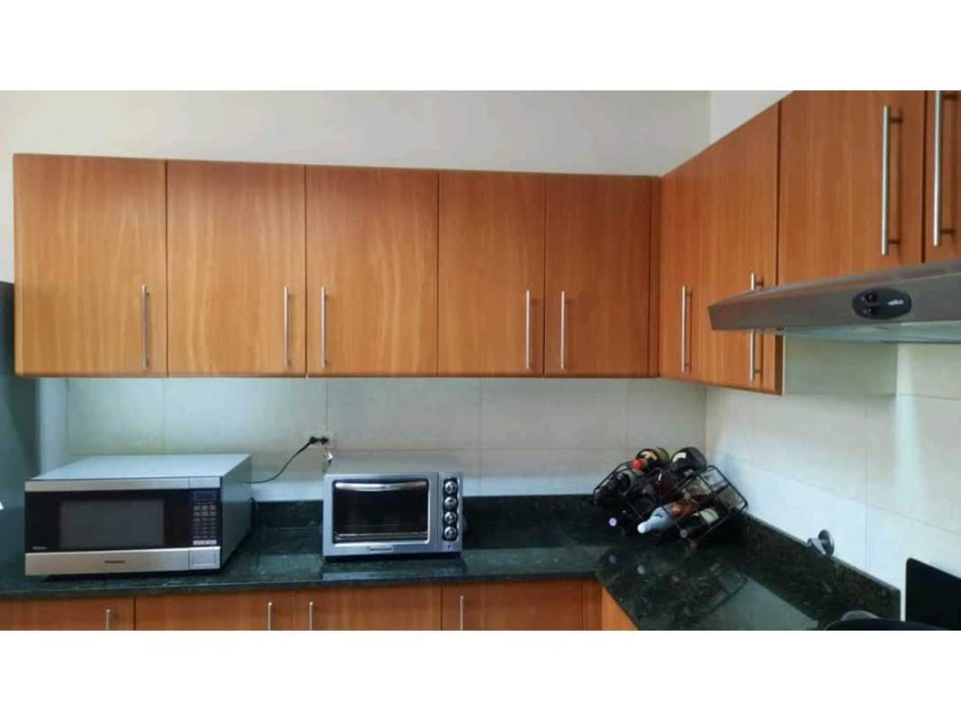 Kitchen featuring wooden cabinets, granite countertops, stainless steel appliances PH Diana Tower Obarrio Panama