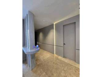 Modern kitchen with marble counters, dining space, large windows at PH Q Tower