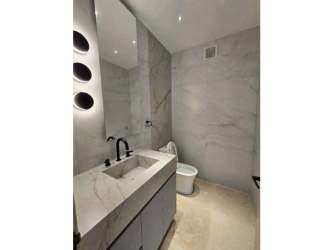 Spacious master bedroom with panoramic ocean view, wood panel wall in PH Q Tower Panama