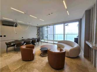 Open living and dining area with ocean views and balcony PH Q Tower