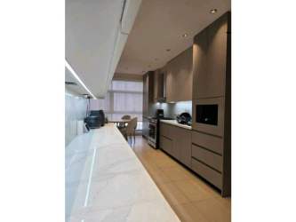 Sleek kitchen with marble countertop, dining space, floor-to-ceiling windows at PH Q Tower