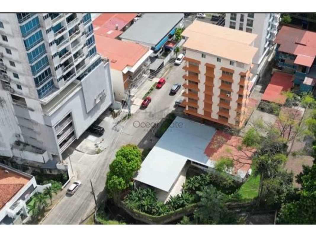 Old house and trees on land lot in El Cangrejo Panama City development zone