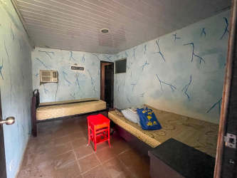 Simple bedroom with tile floors and window for hospitality guest Dolega Chiriquí Panama