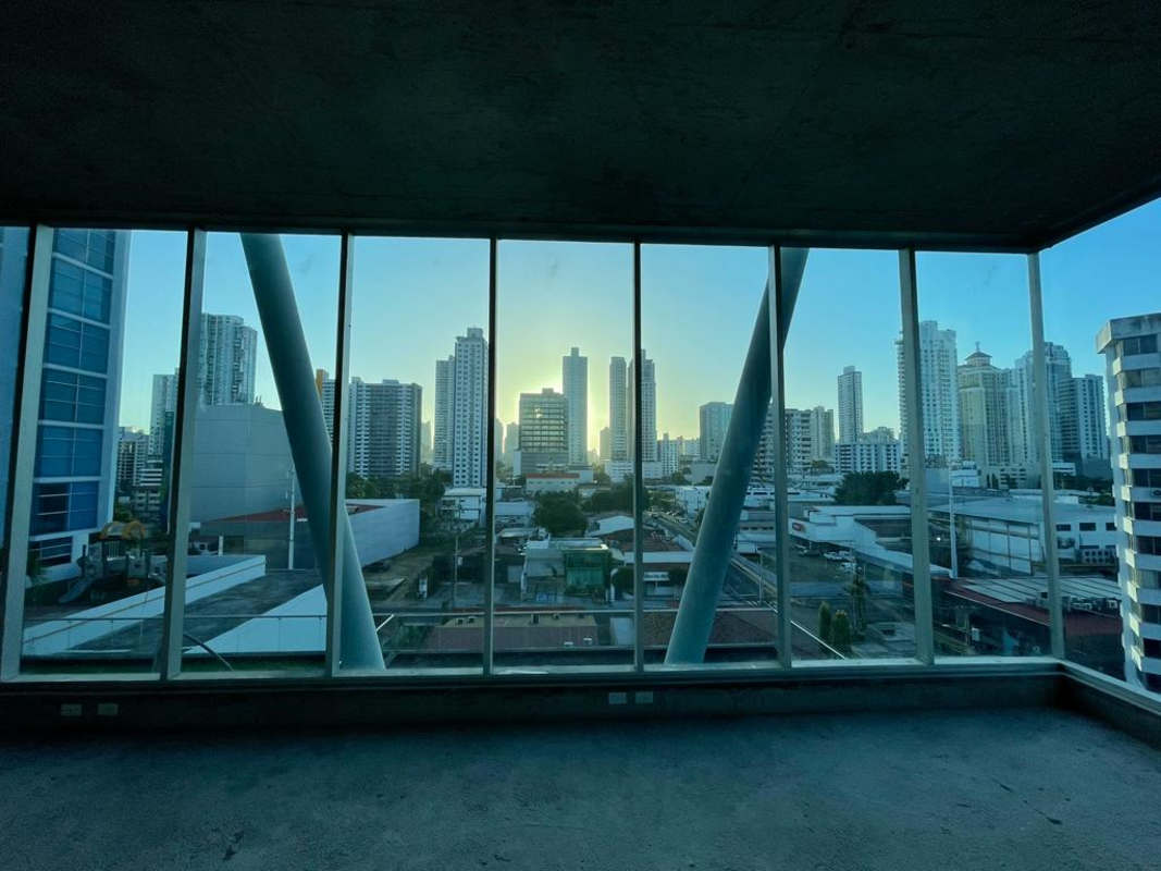 High-rise unfinished office unit with glass walls overlooking Panama City skyline at Office77 San Francisco
