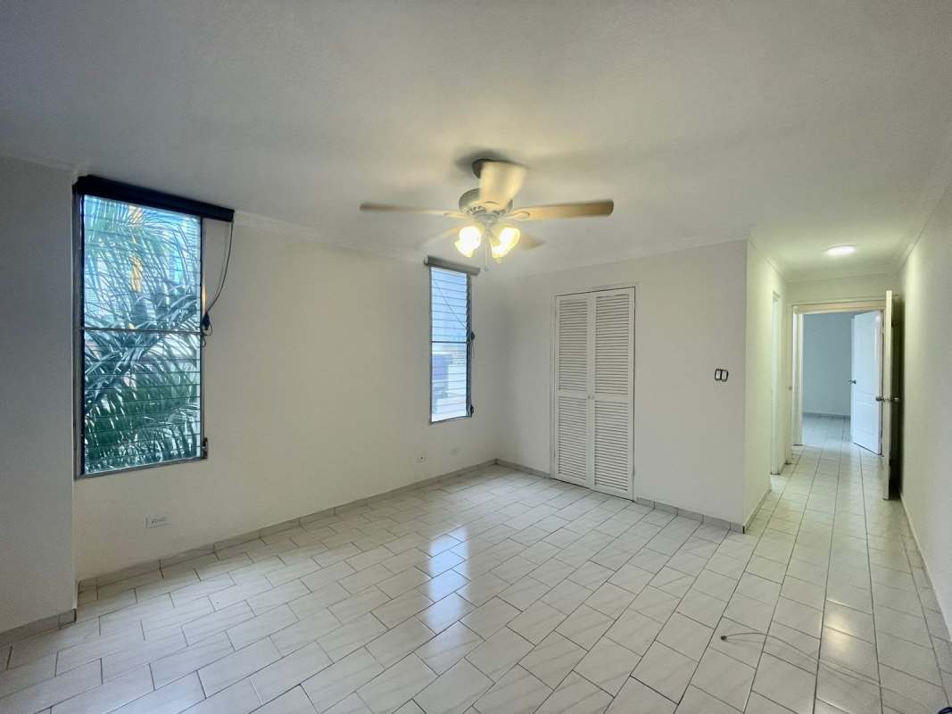Bedroom with tile floor built-in closet adjoining bath PH Ocean View San Francisco Panama City