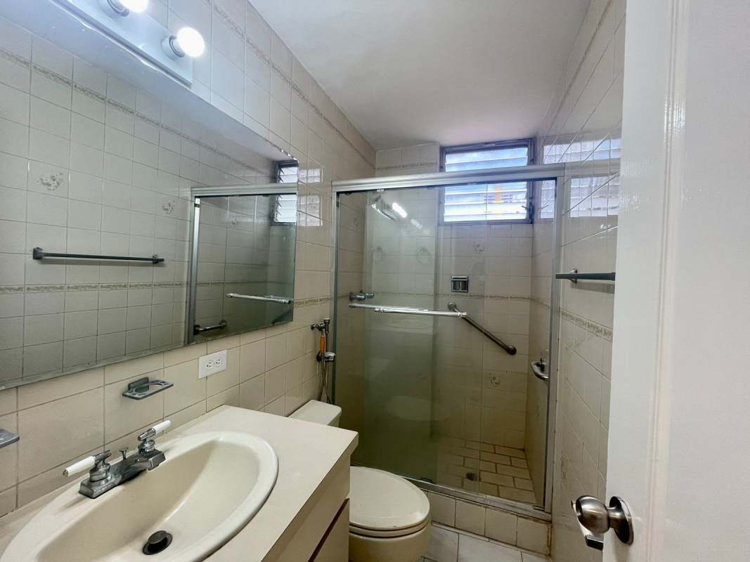 Bathroom with beige tile, glass shower door, vanity PH Ocean View San Francisco Panama City