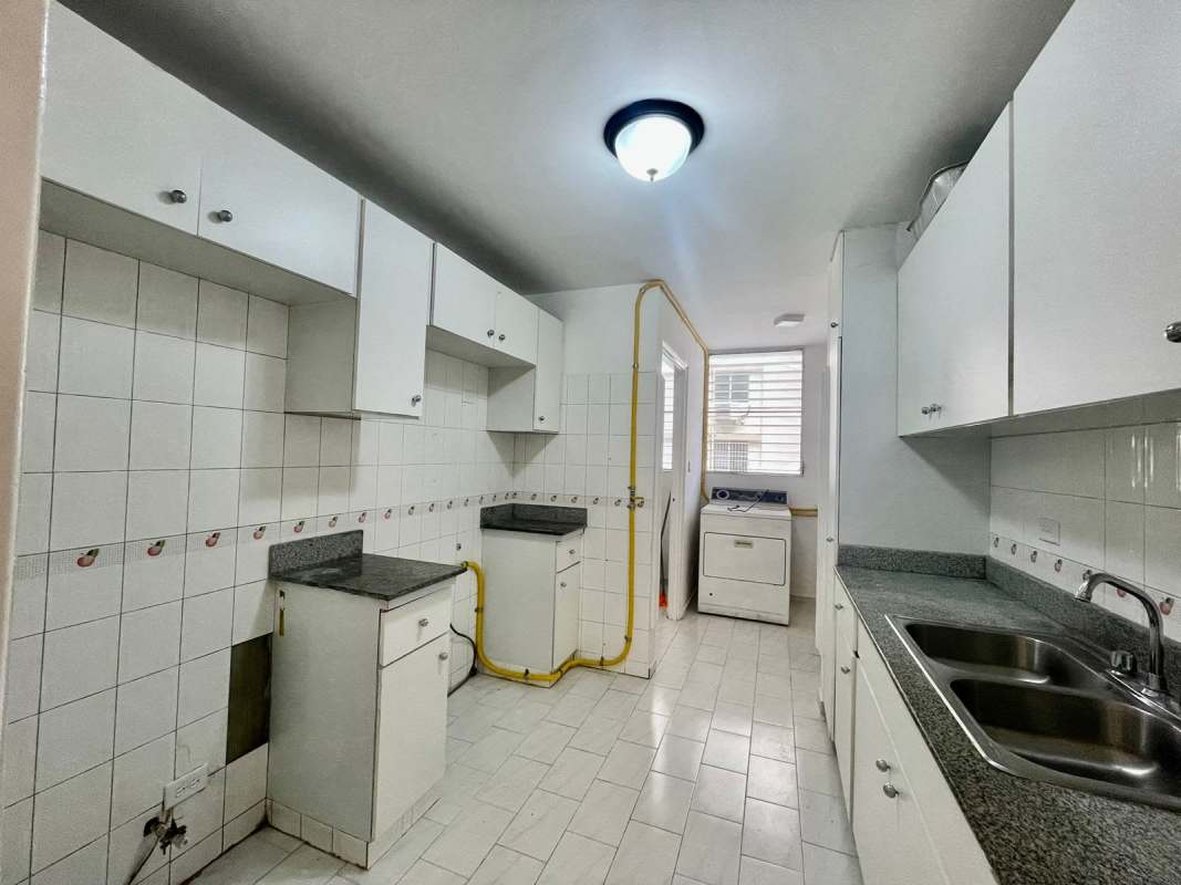 Hallway view of apartment with white shelves, tile floors and bright lighting PH Ocean View San Francisco Panama