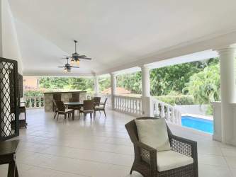 Elegant outdoor terrace bar, ceiling fans, dining area in luxury Coronado golf villa