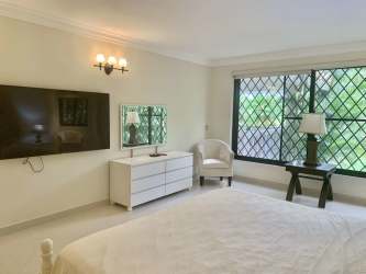 Spacious master bedroom with access to balcony overlooking golf and gardens in Coronado Panama villa