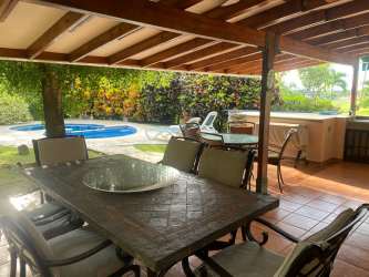 Bathroom with large mirror, ceramic sink and decorative tile at Costa Blanca Villas Panama