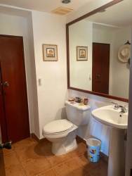 Private tropical backyard with large pool, jacuzzi, thatched gazebo, and hammocks Costa Blanca Villas El Farallón Panama