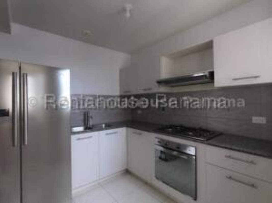 Spacious bright living room with balcony access and ceramic tile floors in Panama apartment