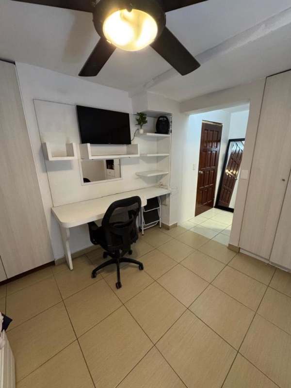 Fully furnished bedroom with work desk closet ceiling fan Panama City