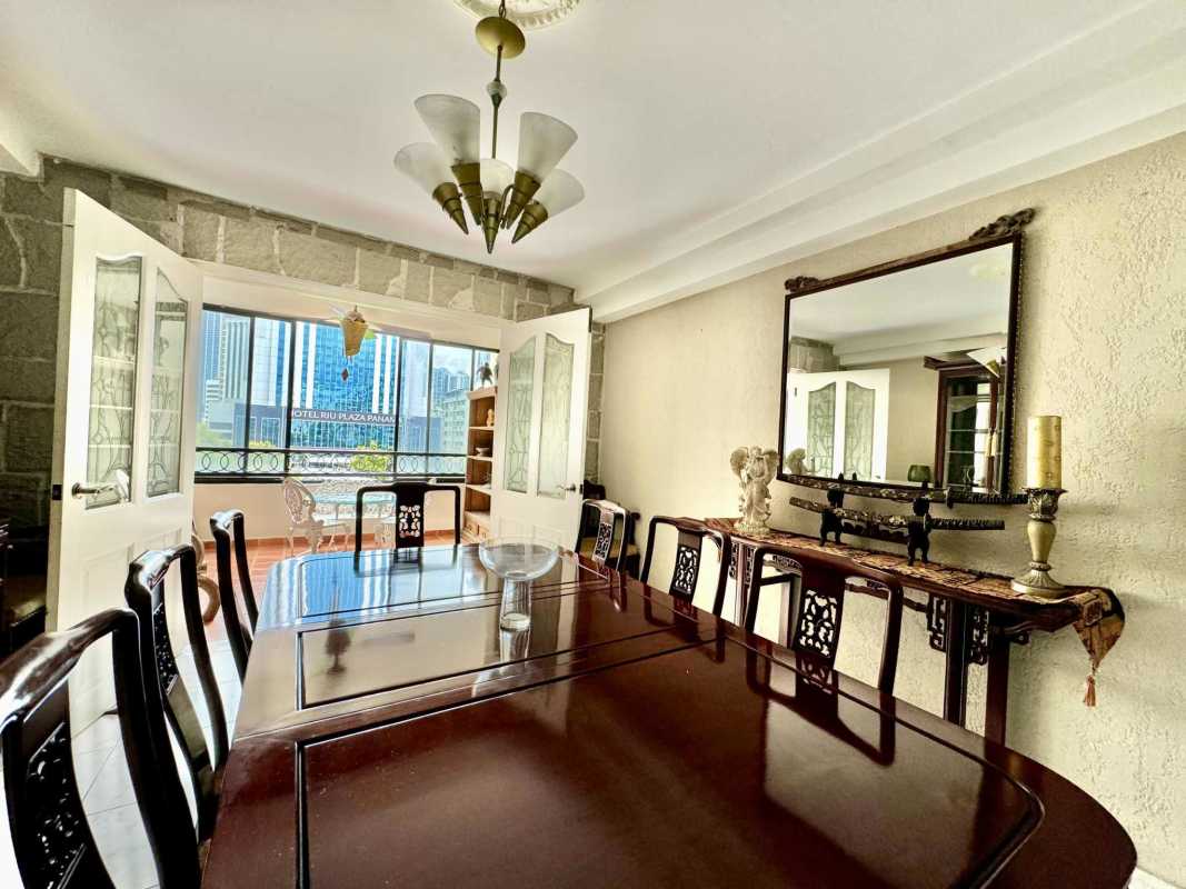 Dining area with wood table, French doors to balcony and city view PH Terrazas de Obarrio Obarrio Panama City