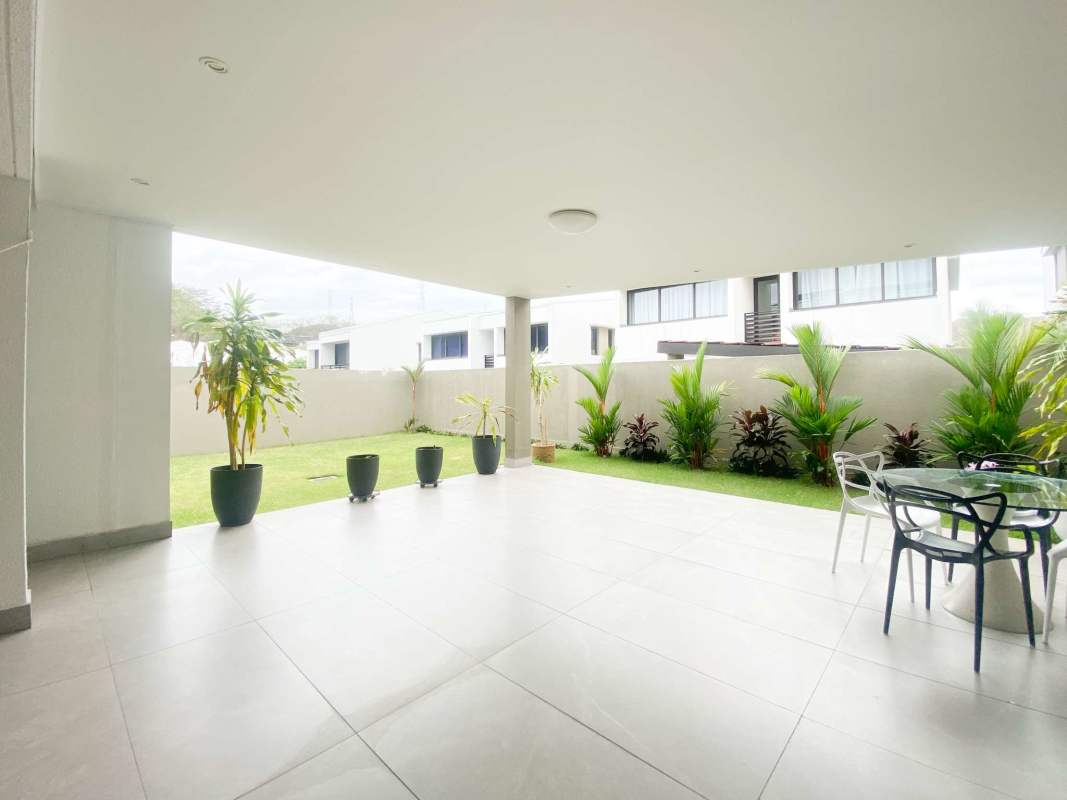 Spacious covered terrace and green garden of luxury home for sale in Altos de Panama