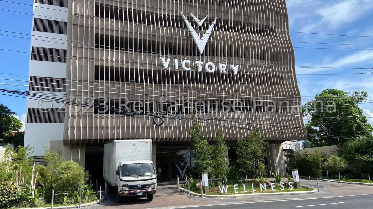 Modern facade Victory Wellness building with vertical louvers and landscaped entry Panama