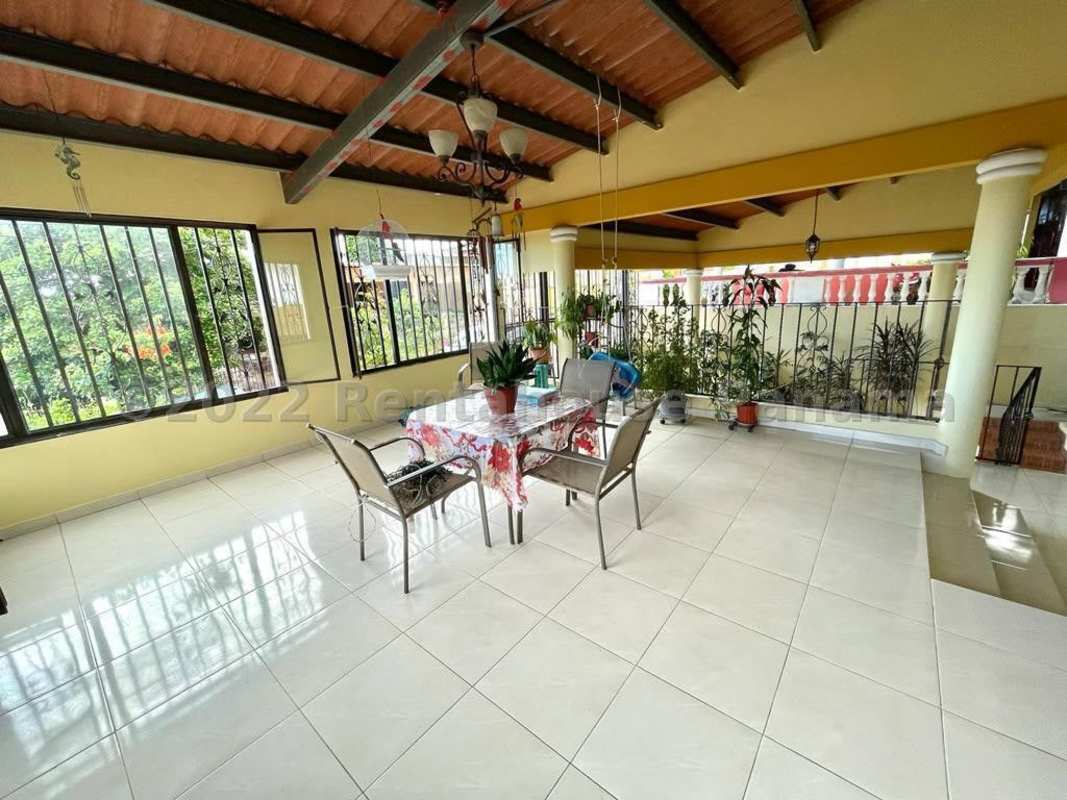 Large fenced backyard with green lawn mature trees Cerro Viento Panama