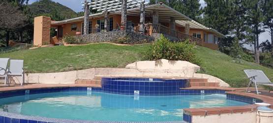 Brick patio with pergola beside swimming pool at mountain property El Valle Panama