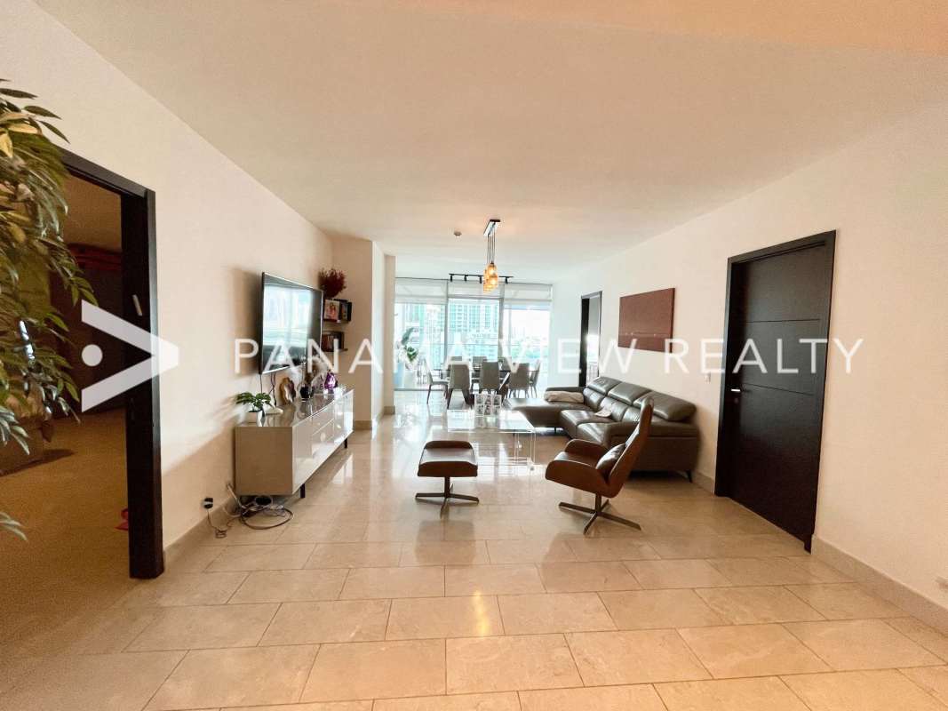 Modern bathroom with marble countertop dual sinks large mirror and glass shower in PH Grand Tower Panama