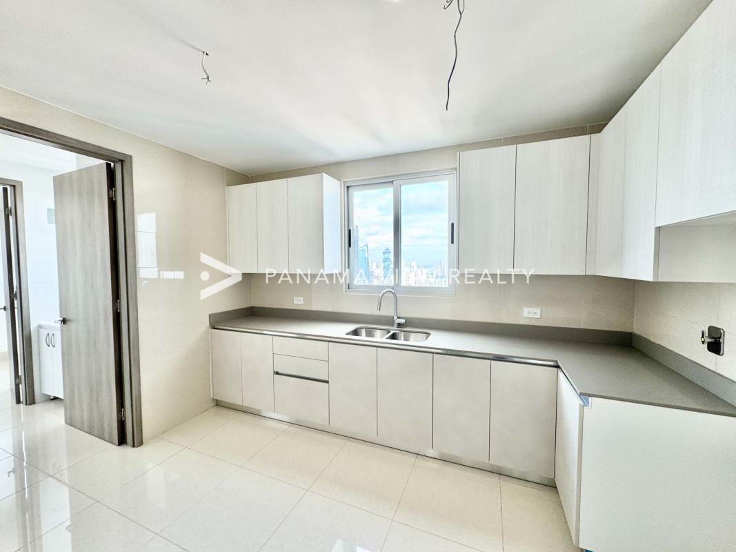 Bright minimalist kitchen with double sink and city skyline window PH Costanera Panama