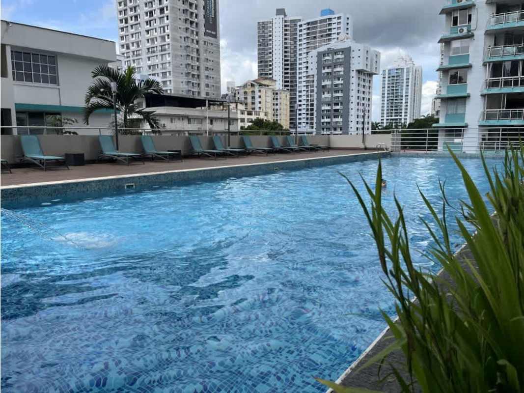 Modern gym with cardio equipment, large mirrors and weights at PH Luxor 100 Panama City