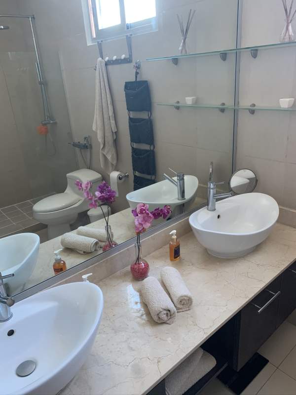 Dining table with city and ocean view large windows in luxury furnished apartment PH Sky Panama