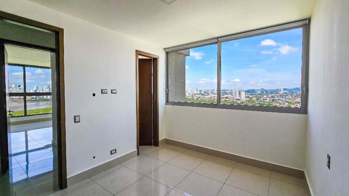 Bright empty living room with tiled floors and balcony PH Bali Costa del Este Panama