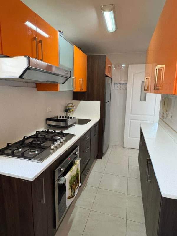 Dining room with stone accent wall, modern furnishings PH Altamira Residences Condado Panama