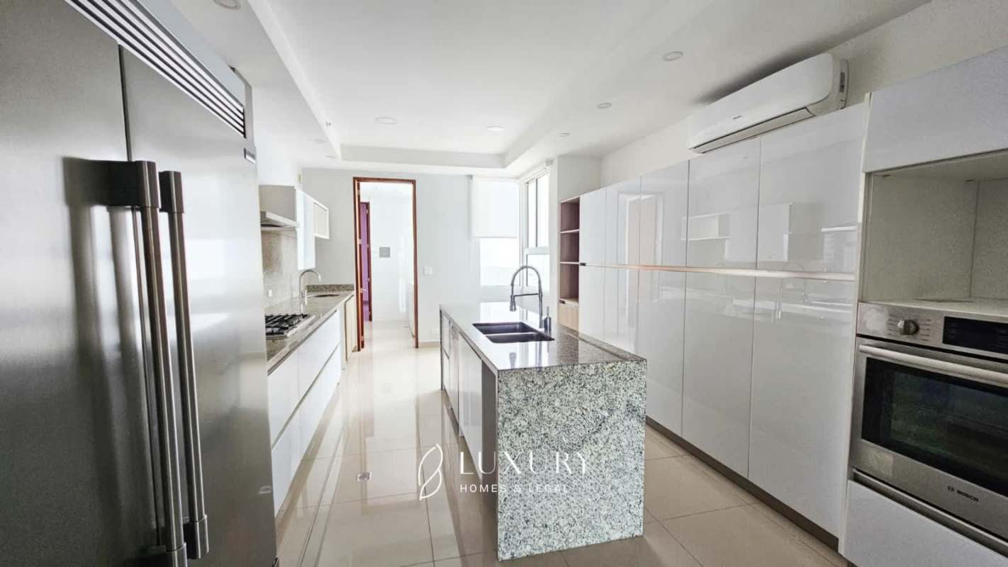 Modern German kitchen with granite island, built-in appliances and glossy cabinets in PH Aria Panama