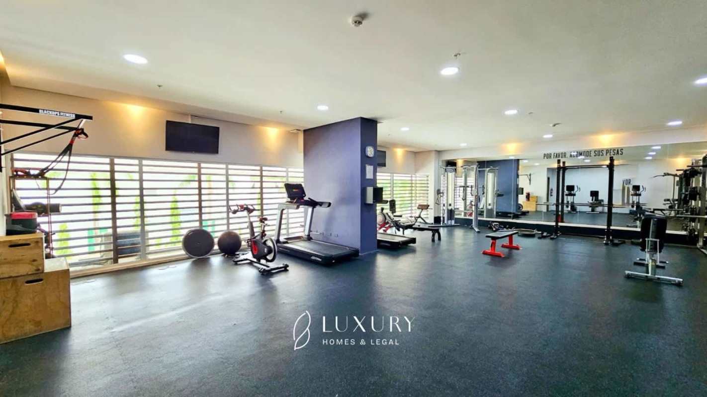 Spacious modern balcony with glass rails overlooking ocean and skyline at PH Aria Costa del Este Panama