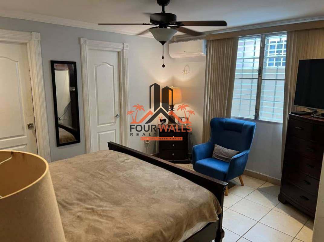 Bedroom with natural light and closet in family home for sale in Brisas del Golf Panama