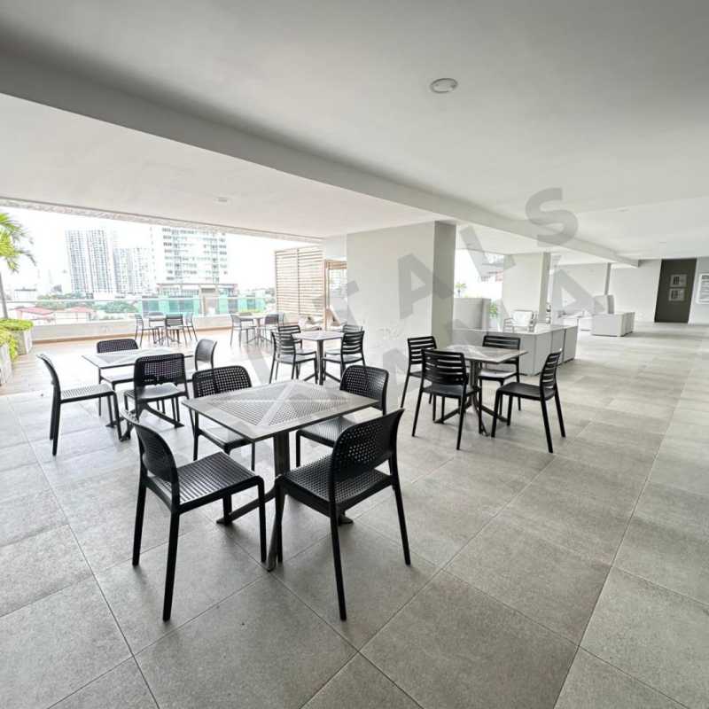 Covered outdoor terrace with dining furniture overlooking city views at Vista Horizonte