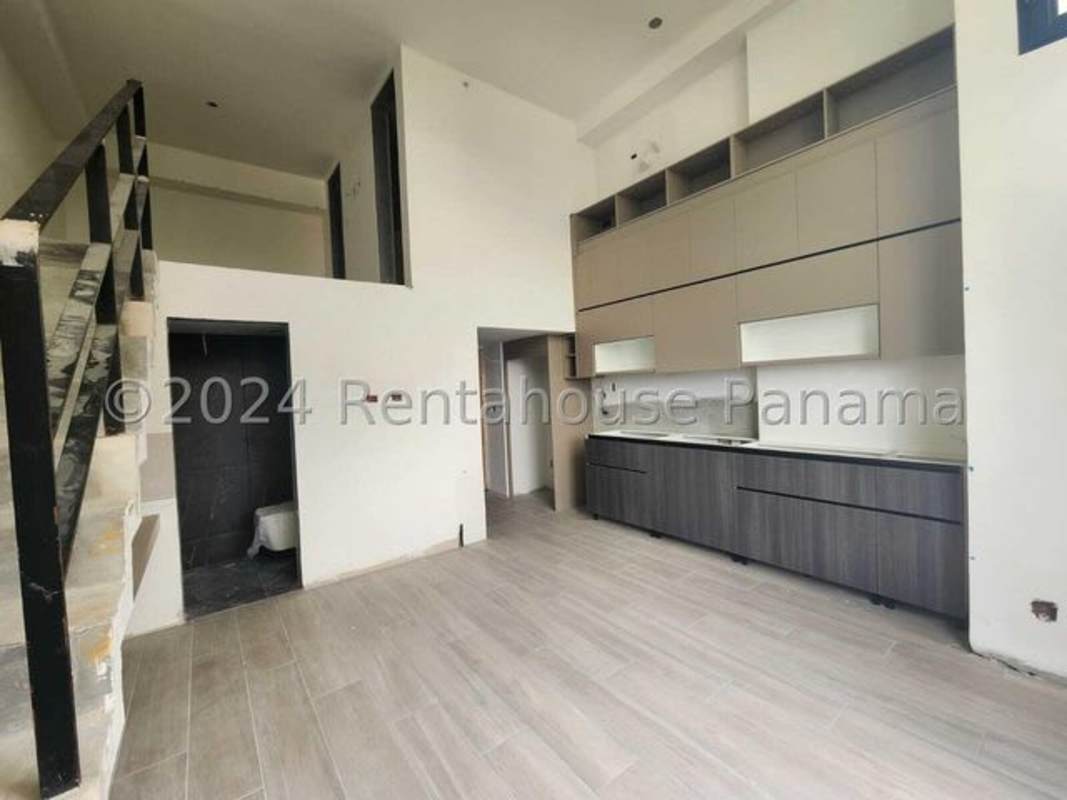 Contemporary open kitchen below mezzanine loft at Coco del Mar Sky Panama