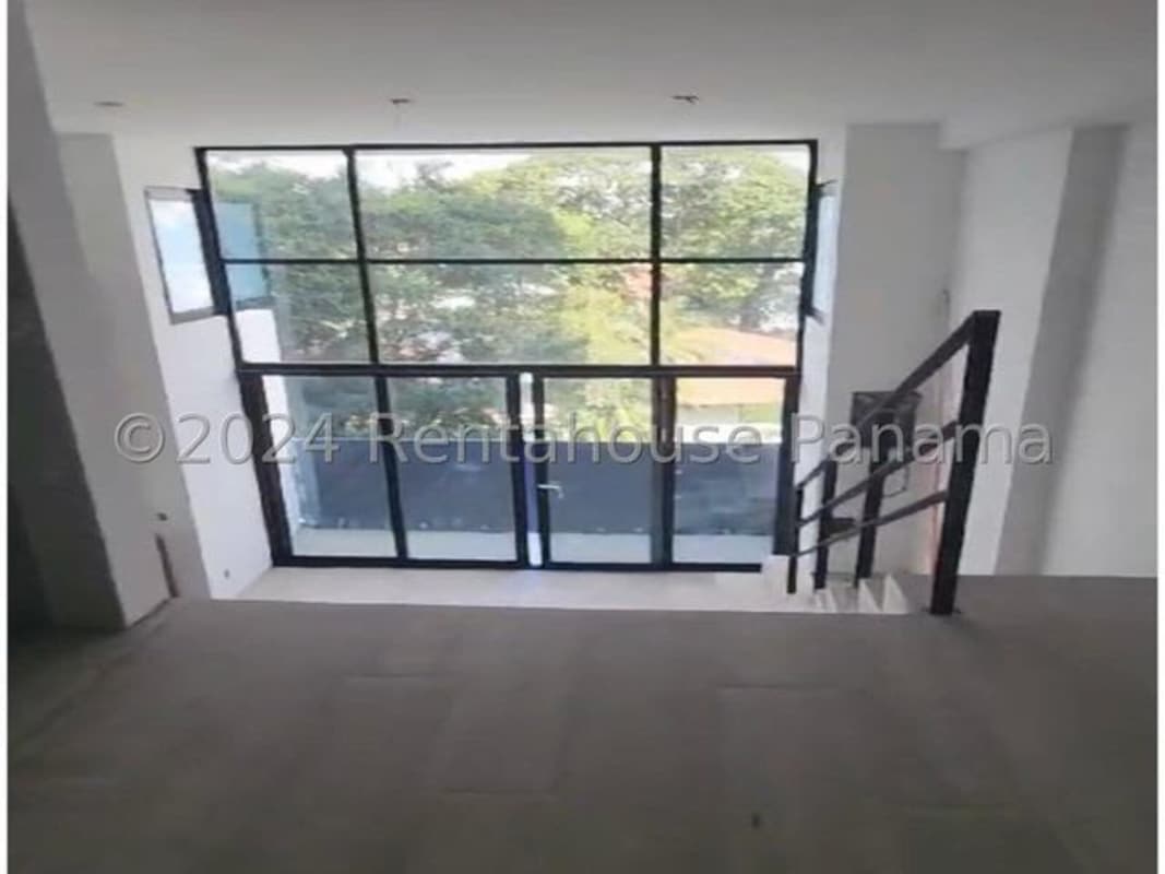 Modern airy double-height living space with large windows Coco del Mar Sky